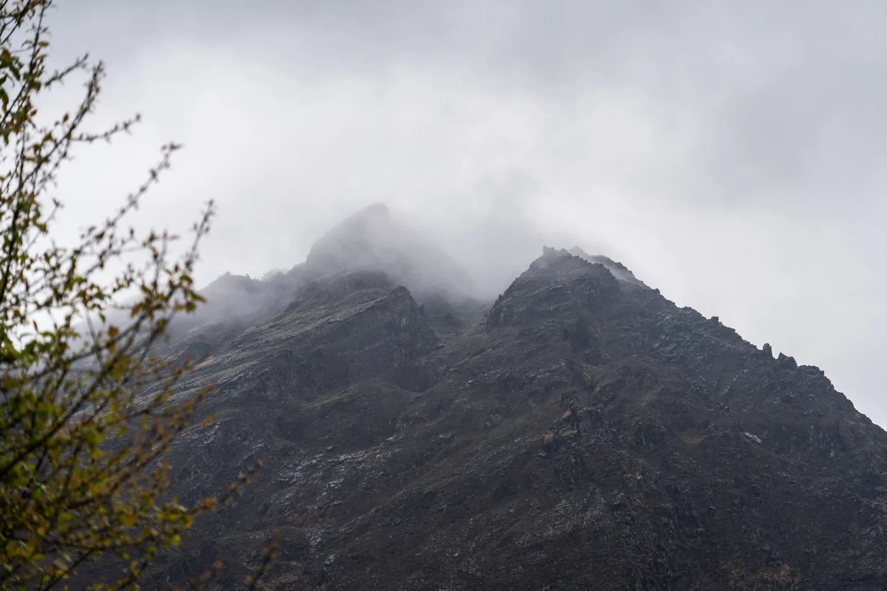 Misty mountain peak emerging from cloud, near the Khurpatal lake walking trail