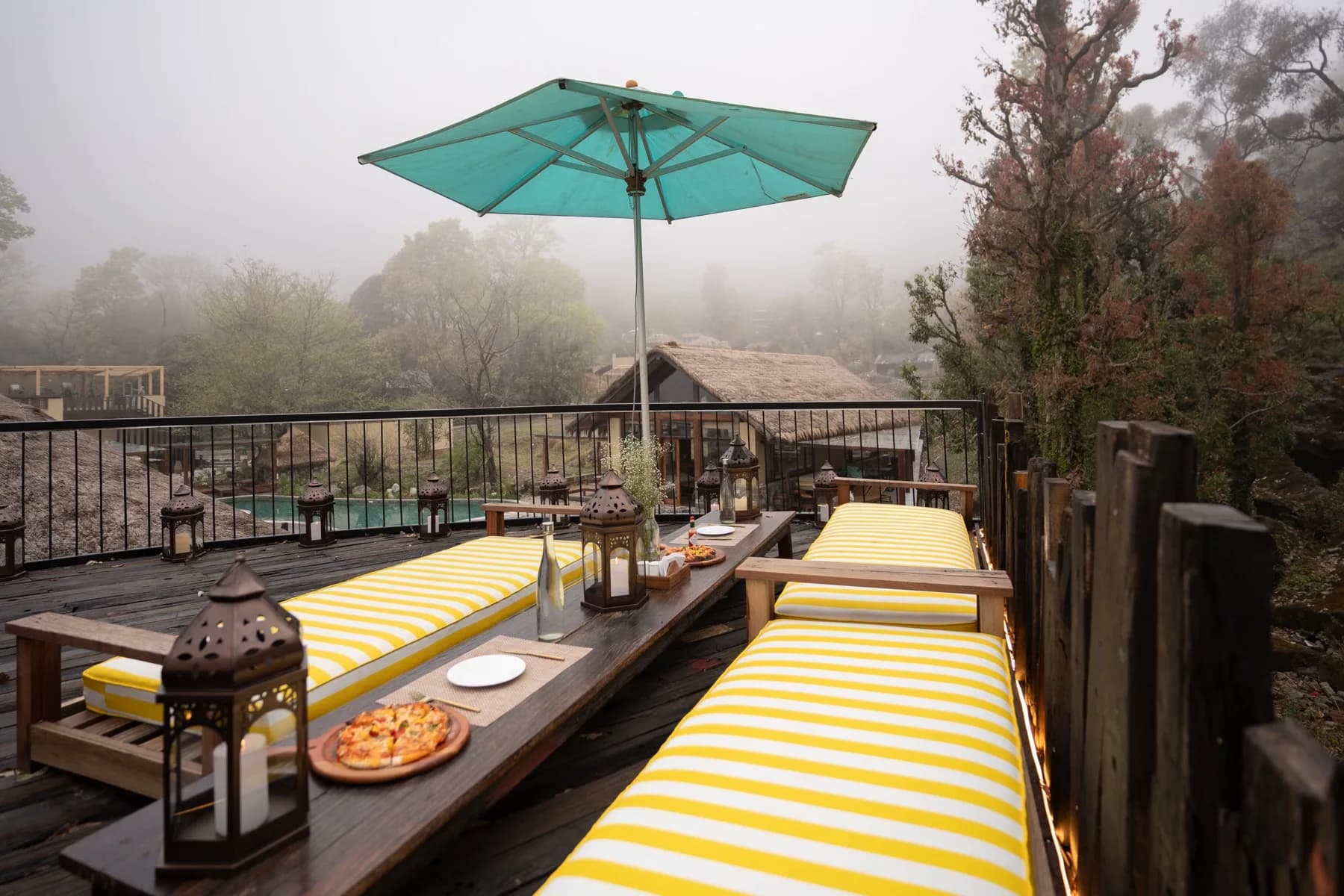 Pizza on a yellow striped daybed deck at Kaansya overlooking the misty hills